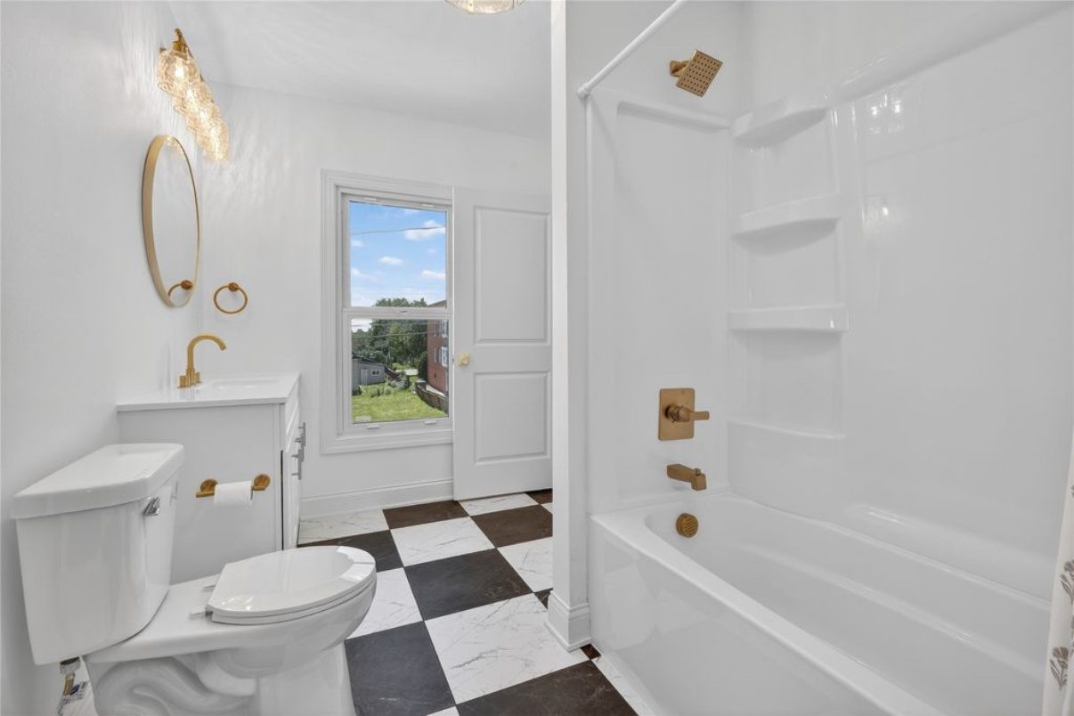 Bathroom remodel featuring gold accents