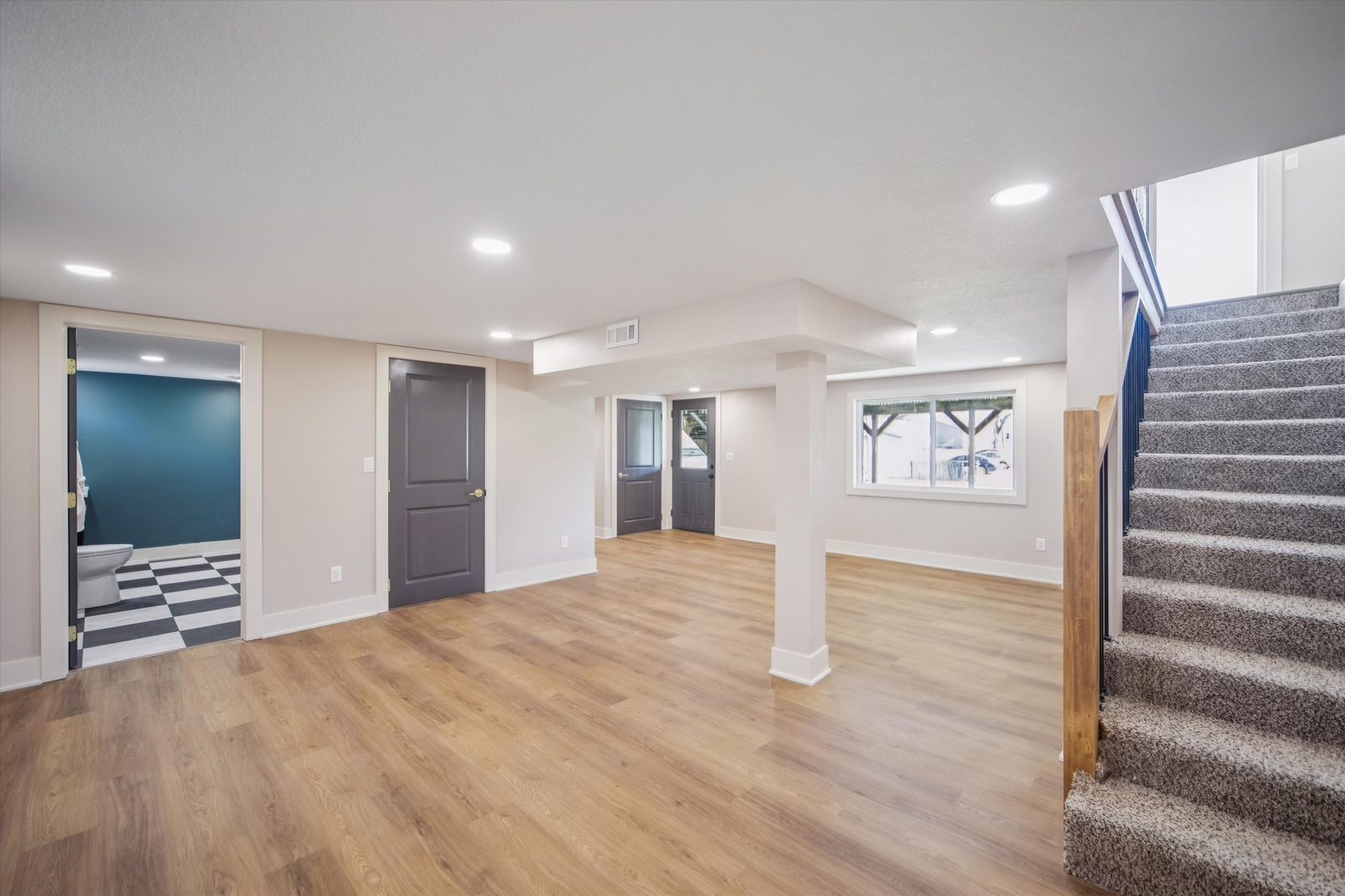 Finished basement living space with clean trim and soft lighting